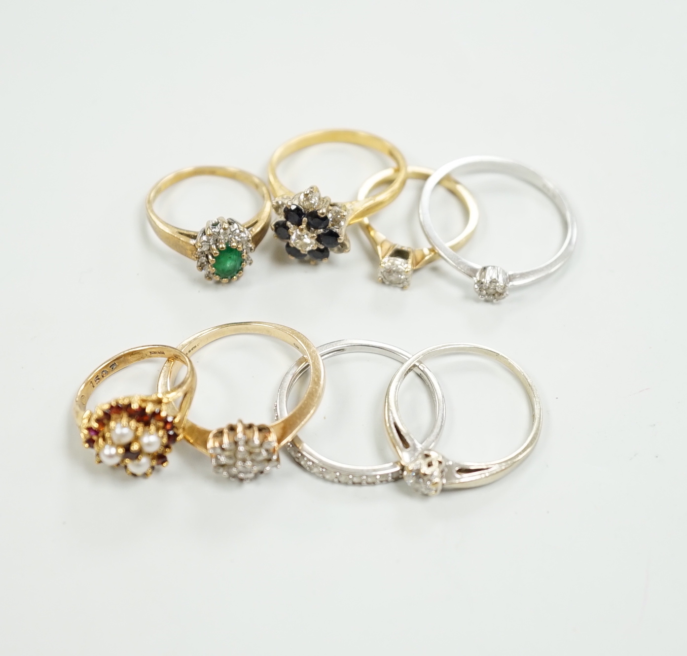 Eight assorted mainly modern 9ct gold and gem set rings, including solitaire diamond and diamond chip half eternity, gross weight 18.8 grams.